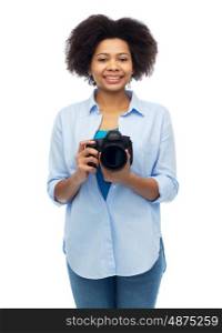 people and photography portrait concept - happy african american young woman with digital camera over white. happy african american woman with digital camera