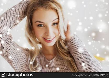 people and portrait concept - close up of happy young woman or teenage girl over snow. close up of happy young woman or teenage girl