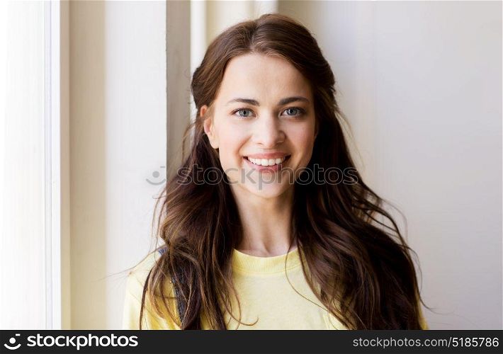 people and portrait concept - happy smiling beautiful young woman or teenage girl. portrait of smiling young woman or teenage girl