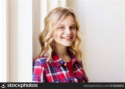 people and portrait concept - happy smiling beautiful young woman or teenage student girl. portrait of smiling young woman or teenage girl