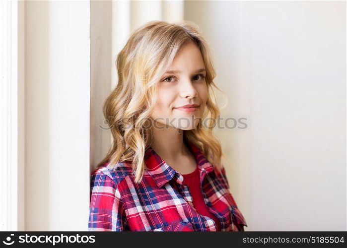 people and portrait concept - happy smiling beautiful young woman or teenage student girl. portrait of smiling young woman or teenage girl