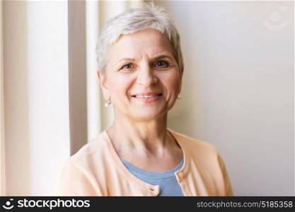 people and portrait concept - happy smiling gray senior woman. portrait of happy smiling gray senior woman