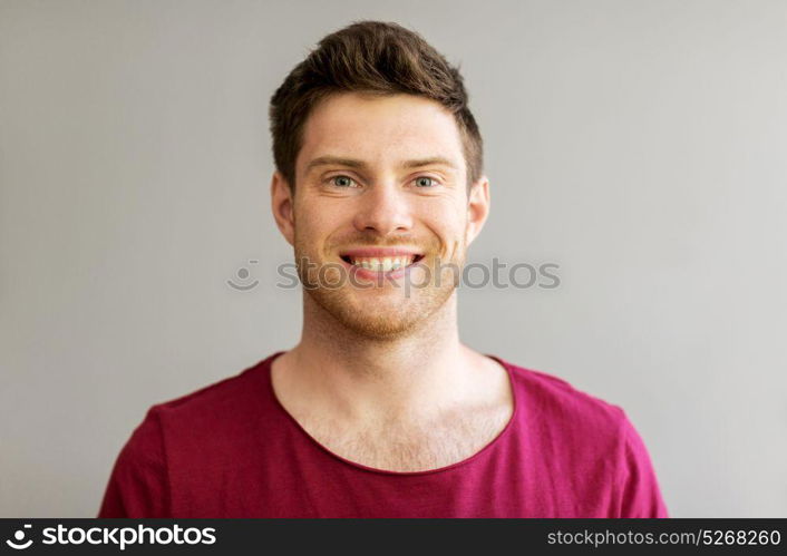 people and portrait concept - happy smiling handsome young man. portrait of happy smiling handsome young man