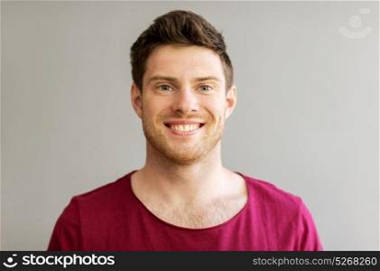 people and portrait concept - happy smiling handsome young man. portrait of happy smiling handsome young man