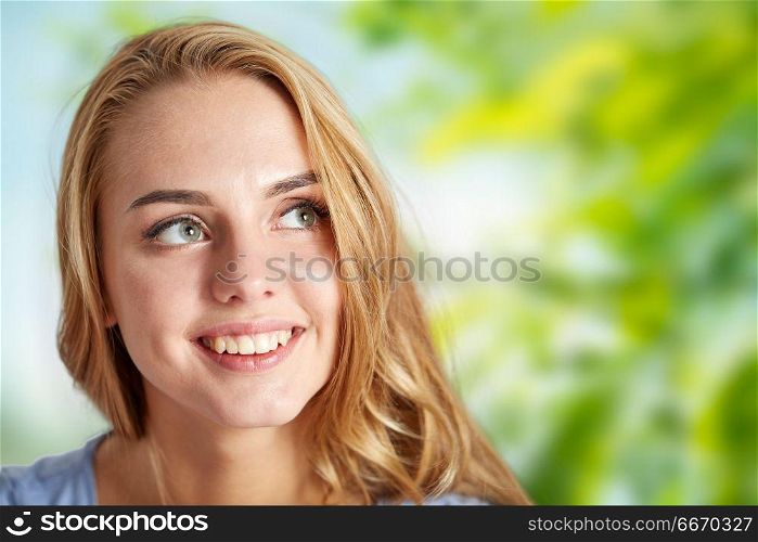 people and portrait concept - happy woman face over green natural background. happy young woman face over natural background. happy young woman face over natural background