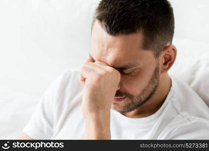 people and problem concept - close up of man in bed thinking. close up of man in bed thinking