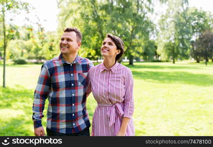 people and relationships concept - happy couple in summer park. happy couple in summer park