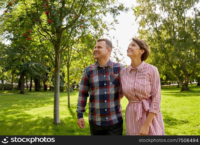 people and relationships concept - happy couple in summer park. happy couple in summer park
