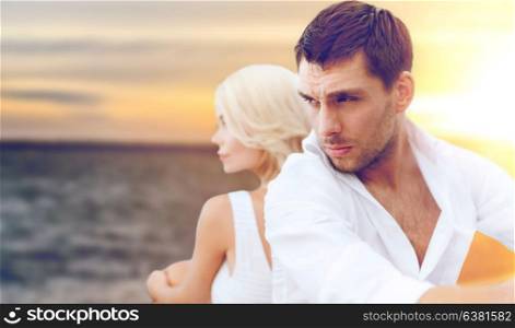 people and relationships concept - unhappy couple over sea background. unhappy couple over sea background