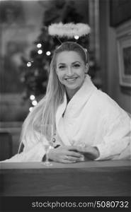 people, and relaxation concept beautiful young woman in bath robe drinking champagne at spa over holidays lights background
