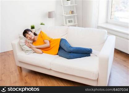 people and rest concept - young asian woman sleeping on sofa at home. young asian woman sleeping on sofa at home