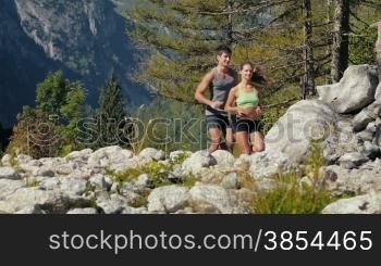 People and sport activity, young man and woman running on mountain trail. Slow motion. Part 1 of 4