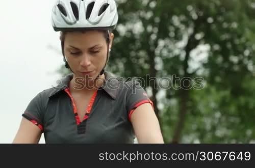 People and sports activities, young woman cycling and training on mountain bike in park. Sequence