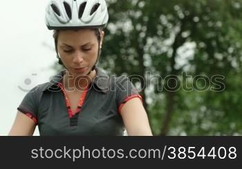 People and sports activities, young woman cycling and training on mountain bike in park. Sequence