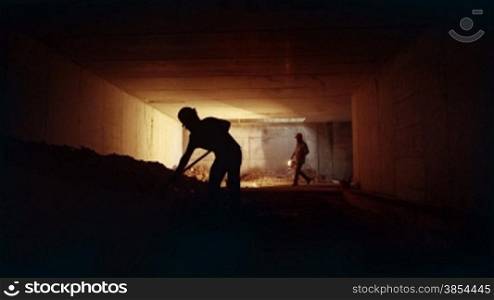 People and teamwork, team of two men at work in new building, construction workers working together in underground tunnel. Part 11 of 11
