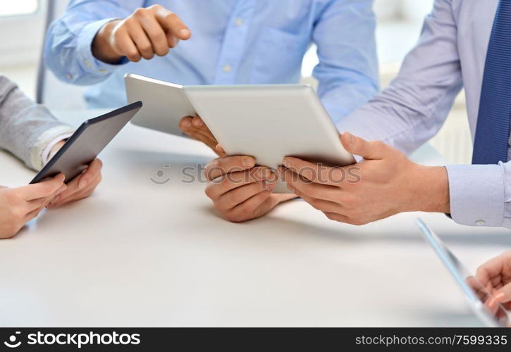 people and technology concept - close up of business team with tablet pc computer at office. close up of business team with tablet pc at office