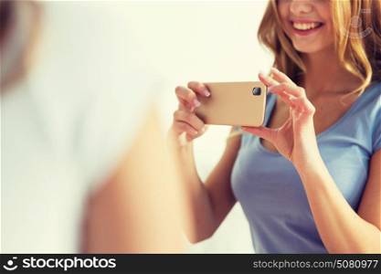 people and technology concept - close up of happy woman or teenage girl with smartphone taking picture at home. close up of teen girl taking picture by smartphone