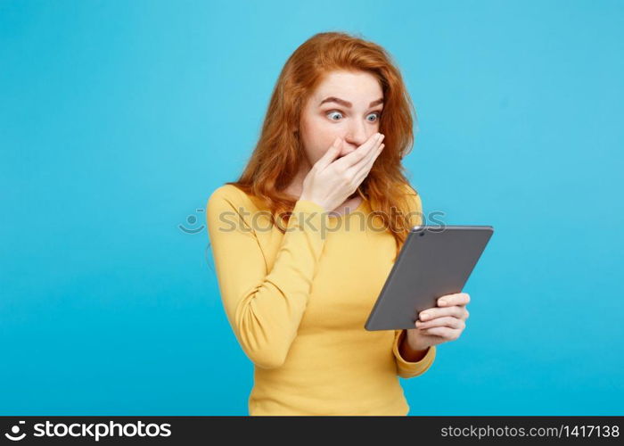 People and Technology Concept - Close up Portrait young beautiful attractive redhair girl happy smiling on digital table with wining something. Blue Pastel Background. Copy space.. People and Technology Concept - Close up Portrait young beautiful attractive tender ginger redhair girl happy smiling on digital table with wining something. Blue Pastel Background. Copy space.