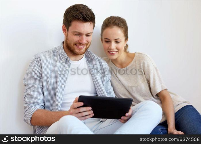 people and technology concept - happy couple with tablet pc computer. happy couple with tablet pc computer