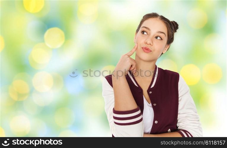 people and teens concept - happy pretty teenage girl thinking over green summer holidays lights background. happy pretty teenage girl thinking