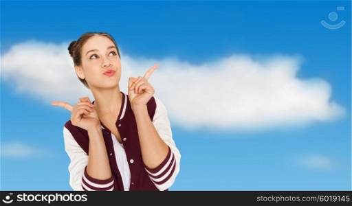 people and teens concept - happy pretty teenage girl with eye makeup over blue sky and clouds background. happy pretty teenage girl