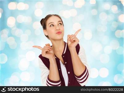 people and teens concept - happy pretty teenage girl with eye makeup over blue holidays lights background. happy pretty teenage girl
