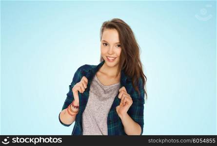 people and teens concept - happy smiling pretty teenage girl over blue background. happy smiling pretty teenage girl