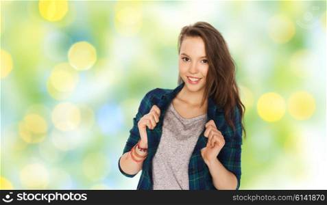 people and teens concept - happy smiling pretty teenage girl over green summer holidays lights background. happy smiling pretty teenage girl