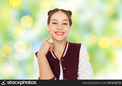 people and teens concept - happy smiling pretty teenage girl with eye makeup over green summer holidays lights background. happy smiling pretty teenage girl