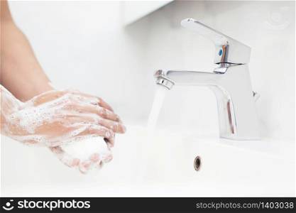 People are washing their hands with soap to protect against Covid 19 virus and bacteria.