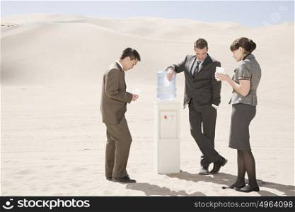 People around water cooler in the desert