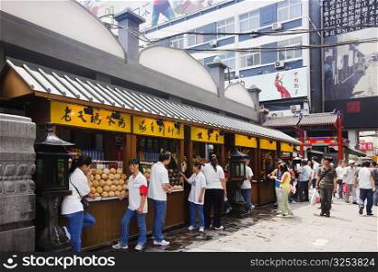 People at a food stall in a market, Wangfujing, Dongcheng District, Beijing, China