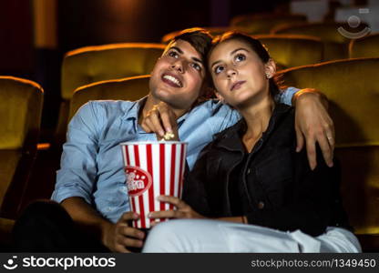 People audience watching movie in the movie theater cinema. Group recreation activity and entertainment concept.