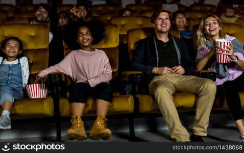 People audience watching movie in the movie theater cinema. Group recreation activity and entertainment concept.