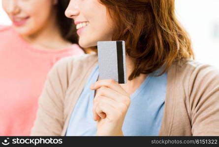 people, banking, shopping, technology and finance concept - close up of women or friends with credit card