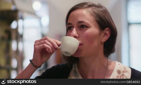 People, bar, cafeteria, girl, female client drinking espresso coffee, woman sipping and enjoying drink from cup. 2of6