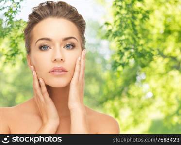 people, beauty and skin care concept - face of beautiful woman over green natural background. face of beautiful woman over background