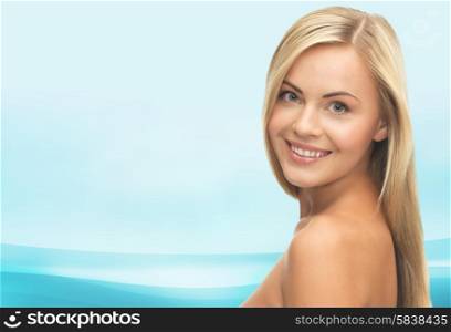 people, beauty, body and skin care concept - beautiful woman face and hands over blue waves background