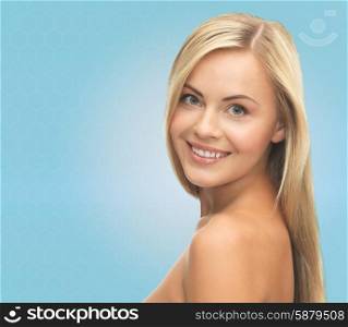 people, beauty, body and skin care concept - beautiful woman face and hands over blue background