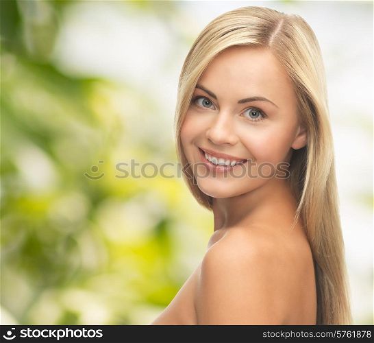 people, beauty, body and skin care concept - beautiful woman face and hands over green background