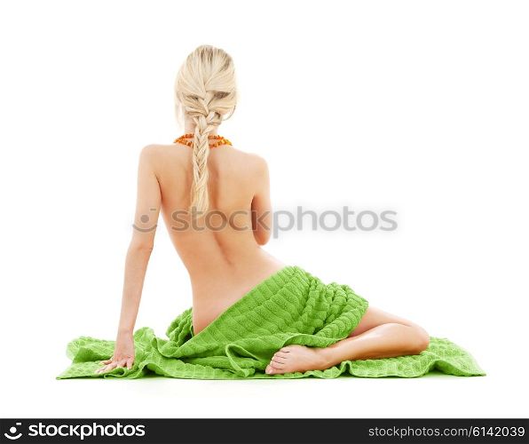 people, beauty, body care and spa concept - beautiful bare woman with green towel from back