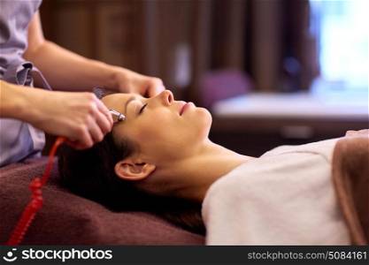 people, beauty, cosmetology and technology concept - beautiful young woman having needle free mesotherapy or hydradermie facial treatment by microcurrent firming device in spa. woman having hydradermie facial treatment in spa. woman having hydradermie facial treatment in spa