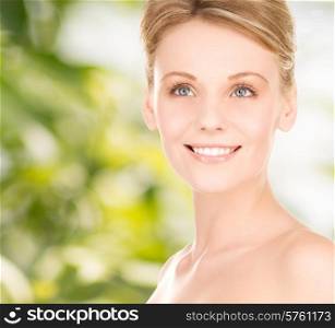 people, beauty, ecology and health care concept - close up of smiling young woman over green background