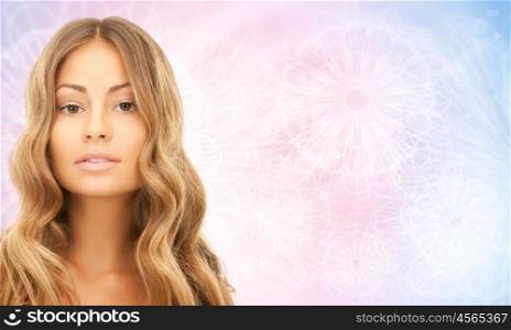 people, beauty, hair and skin care concept - beautiful woman with curly hairstyle over rose quartz and serenity pattern background