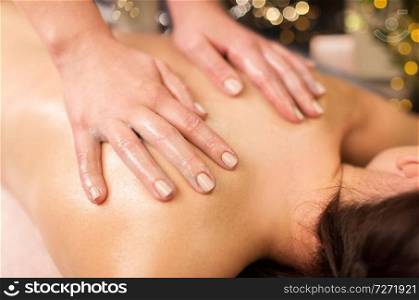 people, beauty, healthy lifestyle and relaxation concept - close up of beautiful young woman lying and having back massage at spa. close up of woman having back massage at spa