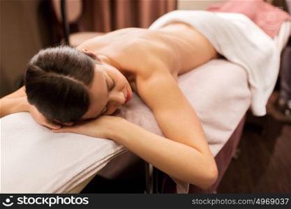 people, beauty, healthy lifestyle and relaxation concept - young woman lying at spa or massage parlor. young woman lying at spa or massage parlor