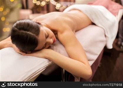 people, beauty, healthy lifestyle and relaxation concept - young woman lying at spa or massage parlor. young woman lying at spa or massage parlor