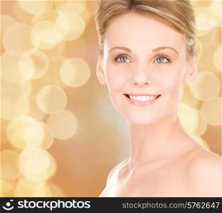 people, beauty, holidays and health care concept - close up of smiling young woman over beige lights background