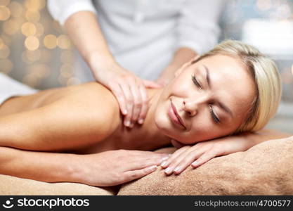 people, beauty, spa, healthy lifestyle and relaxation concept - close up of beautiful young woman lying with closed eyes and having hand massage in spa