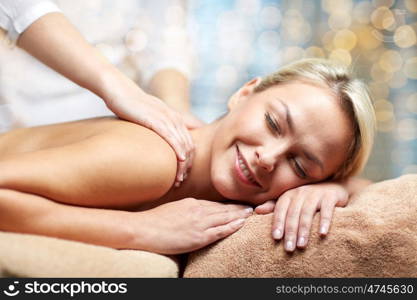 people, beauty, spa, healthy lifestyle and relaxation concept - close up of beautiful young woman lying with closed eyes and having hand massage in spa